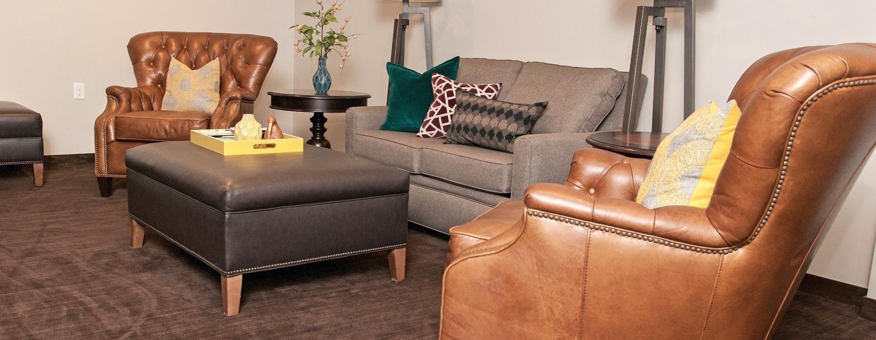 a living room with a couch and chairs