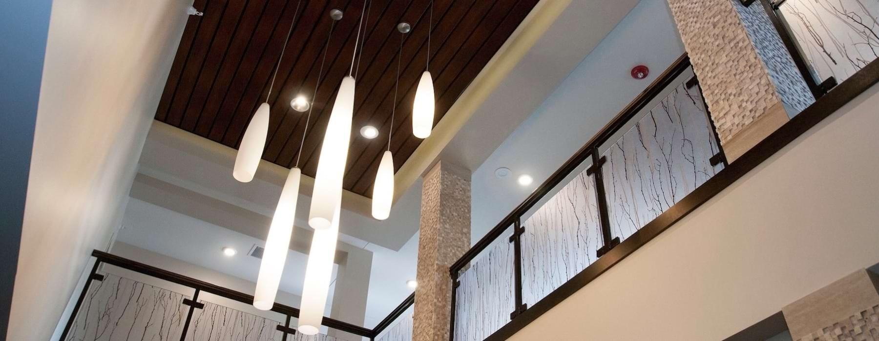 a room with a staircase and a ceiling with lights